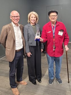 Three people pictured. From left to right is David Dannov, Sally Zemites Dannov, and Paul Seymour.
